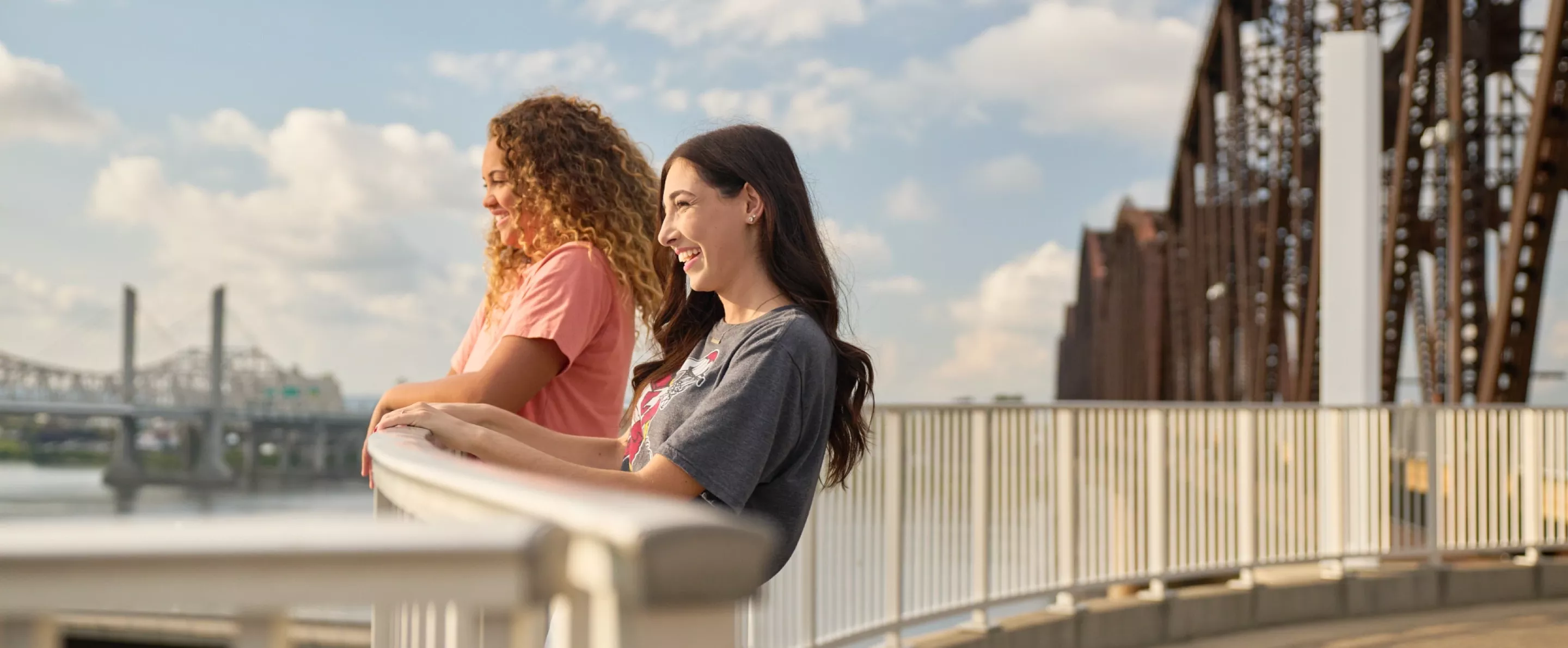 Two students looking at the view from the Big Four Bridge at Waterfront Park in downtown Louisville.