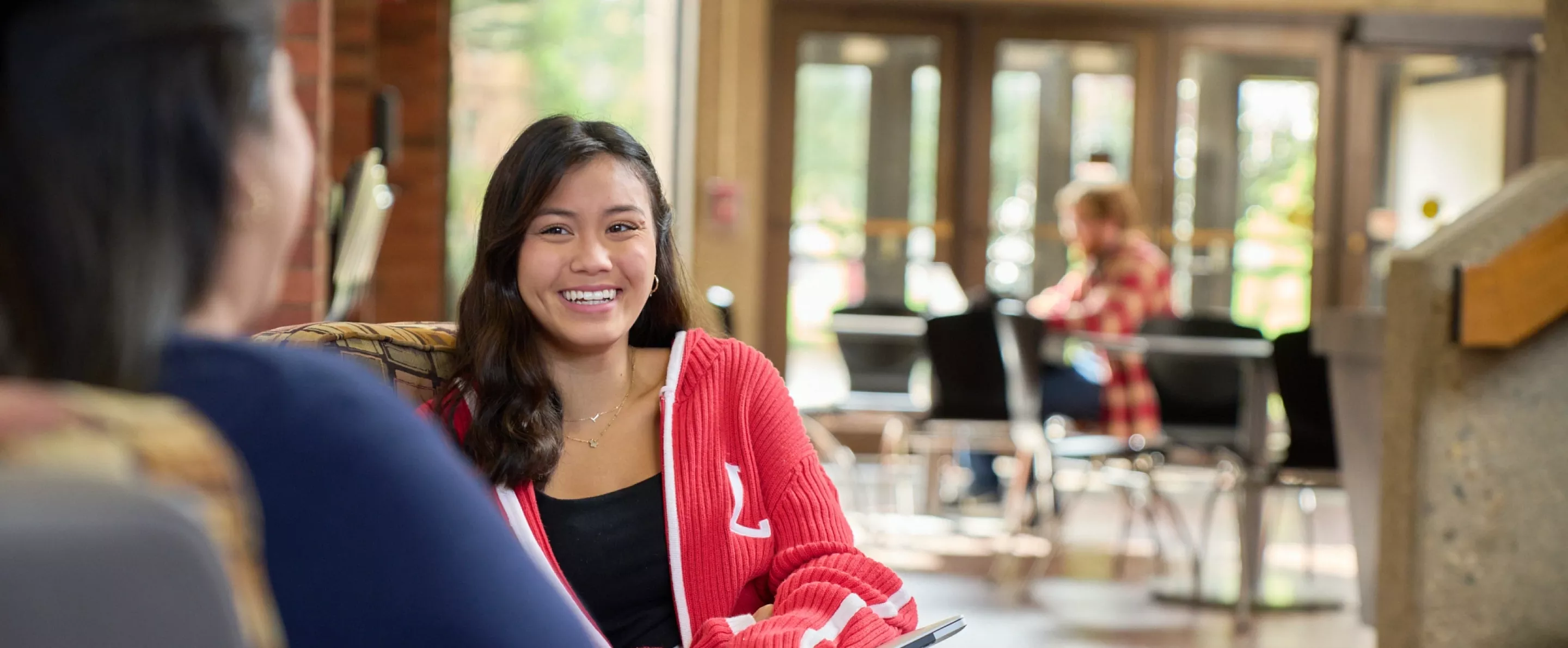 Two students talking in the CEHD.