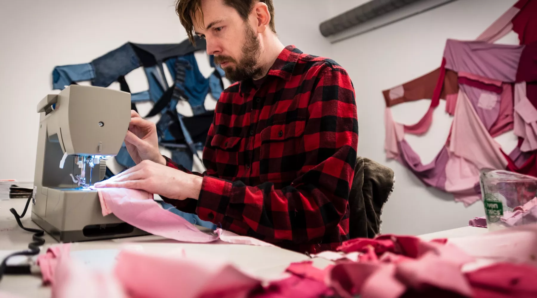 Artist working on a fabric arts piece in their studio