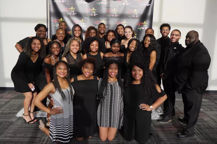 A group of students from CONECT smile at an event.