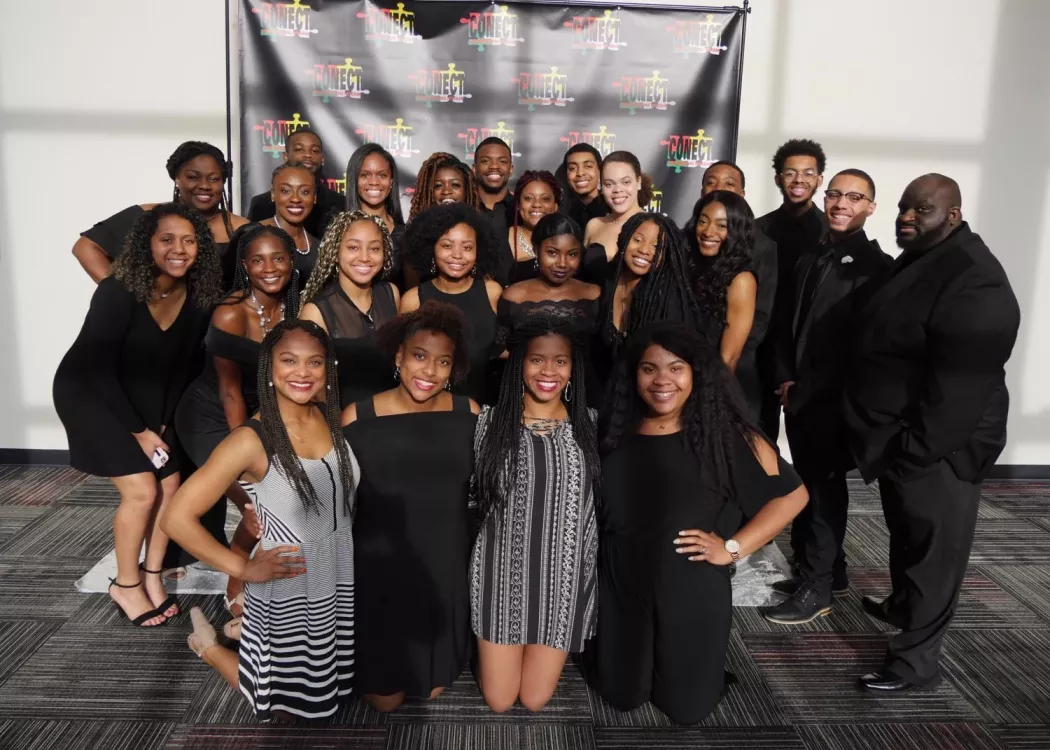 A group of students from CONECT smile at an event.