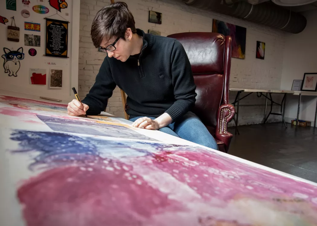 Artist works in their studio in the new Portland MFA Studio