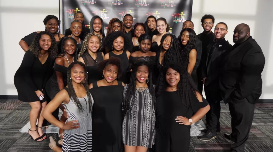 A group of students from CONECT smile at an event.